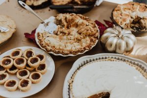 Thanksgiving foods like pie displayed on a dinner table.